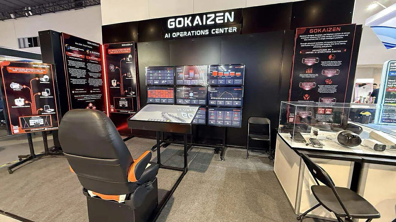 The Gokaizen AI Operations Center: a wall of live security, safety and production dashboards, an operator console and chair, under one operating picture