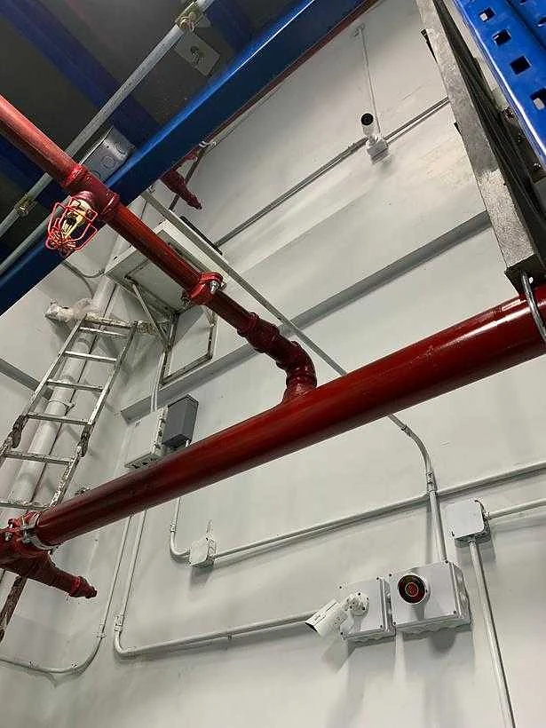 Conduit and cable containment run across a facility ceiling