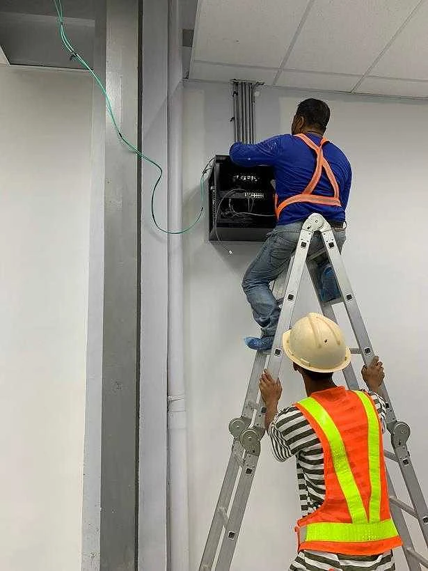 Electrician installing power for a data cabinet