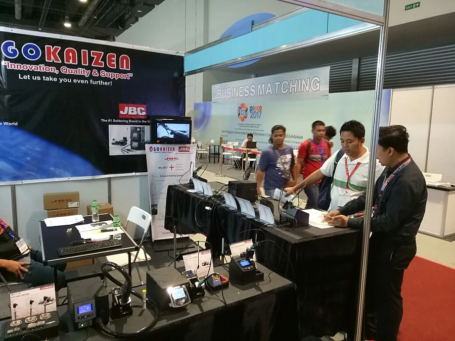 The stand under its banner, soldering stations laid out along the counter