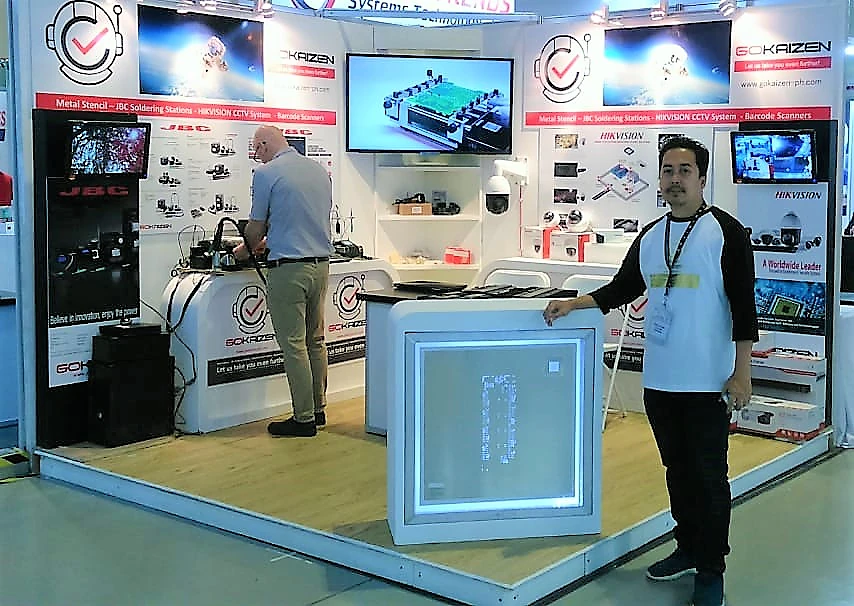 A member of the team beside the lit display cabinet