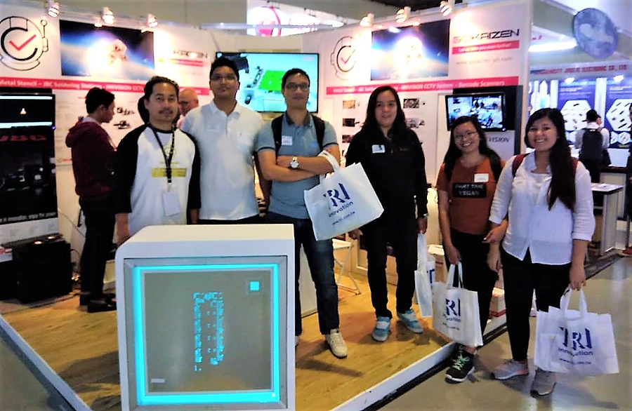 A group gathered at the stand with exhibition bags