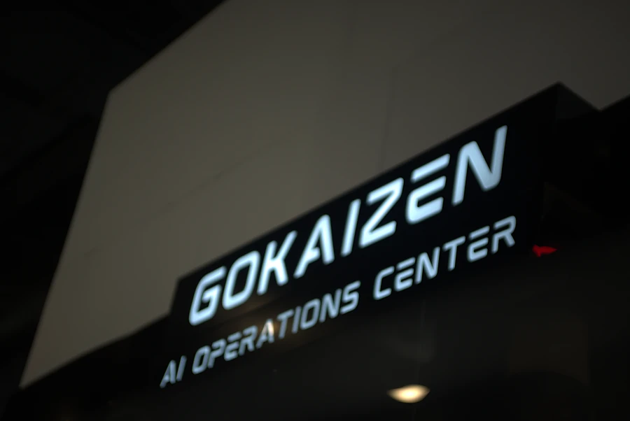 The Gokaizen AI Operations Center sign lit above the stand